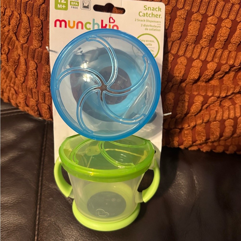 Munchkin Snack Dispenser with Blue Lid and Green Handles